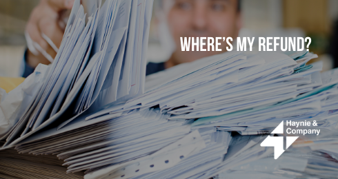 person sorting through pile of envelopes