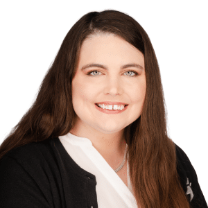 A woman with long brown hair smiling in a professional headshot against a white background.